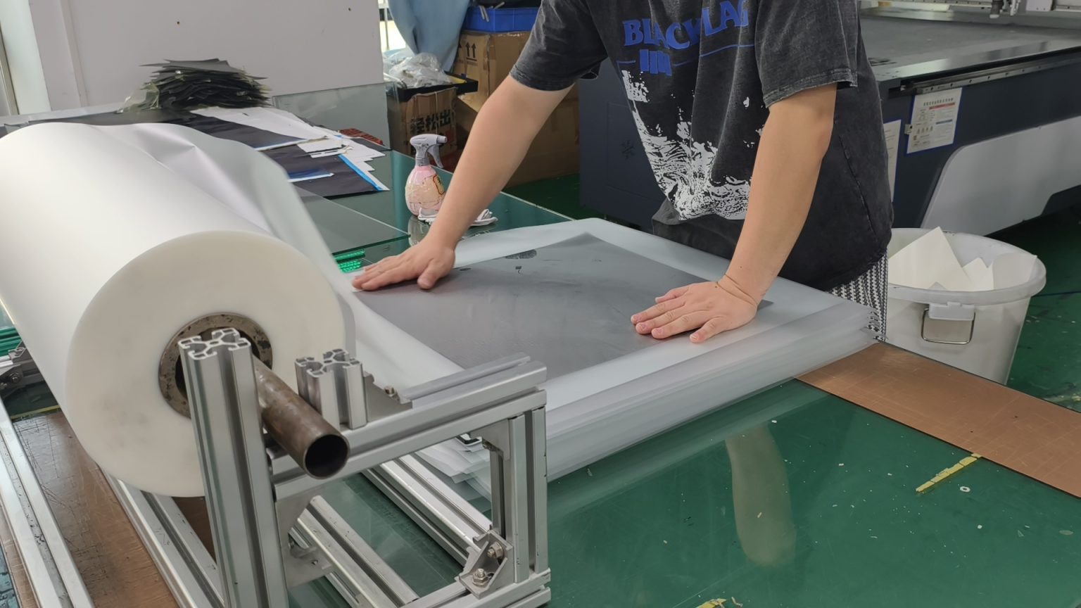 Prepreg plies being laid up by hand for a custom laminate
